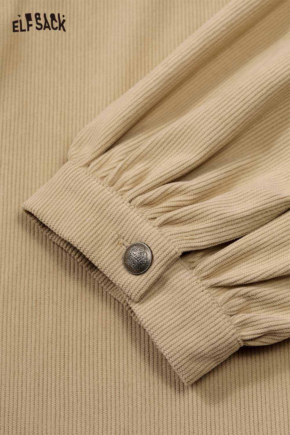 Close-up of ELFSACK soft art print oversized shirt sleeve with button detail in beige color