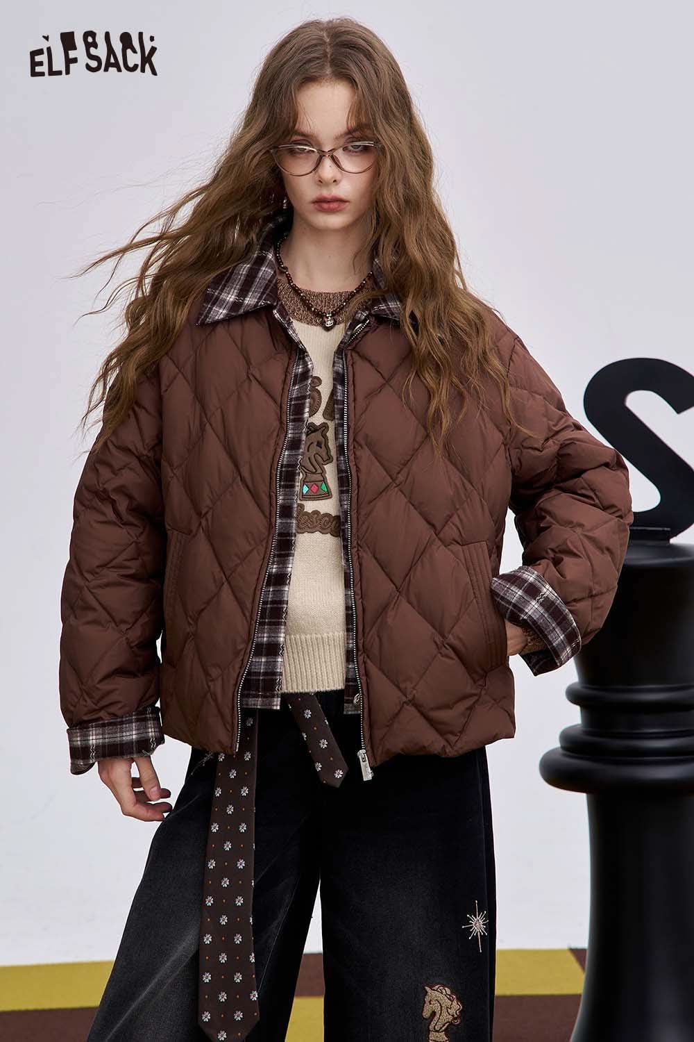 ELFSACK soft graphic knit sweater paired with a brown puffer jacket for a stylish layered look
