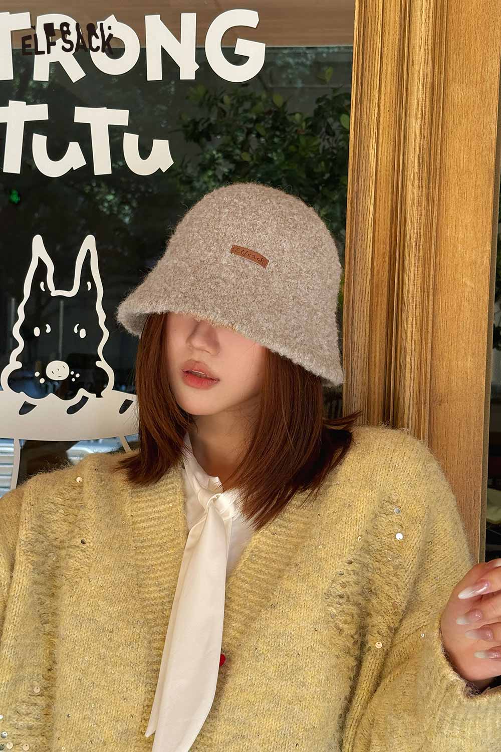 ELFSACK soft wool knit bucket hat in light brown paired with a cozy oversized sweater