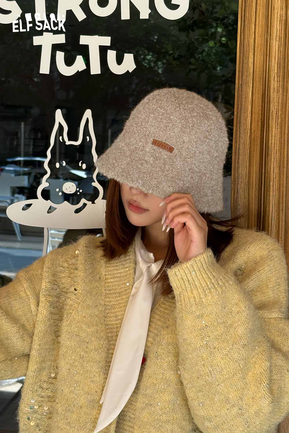 Stylish ELFSACK soft wool knit bucket hat worn with a cozy sweater for a chic look