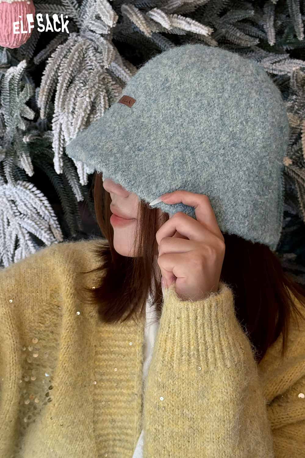 ELFSACK soft wool knit bucket hat in light blue worn stylishly, perfect for chilly days