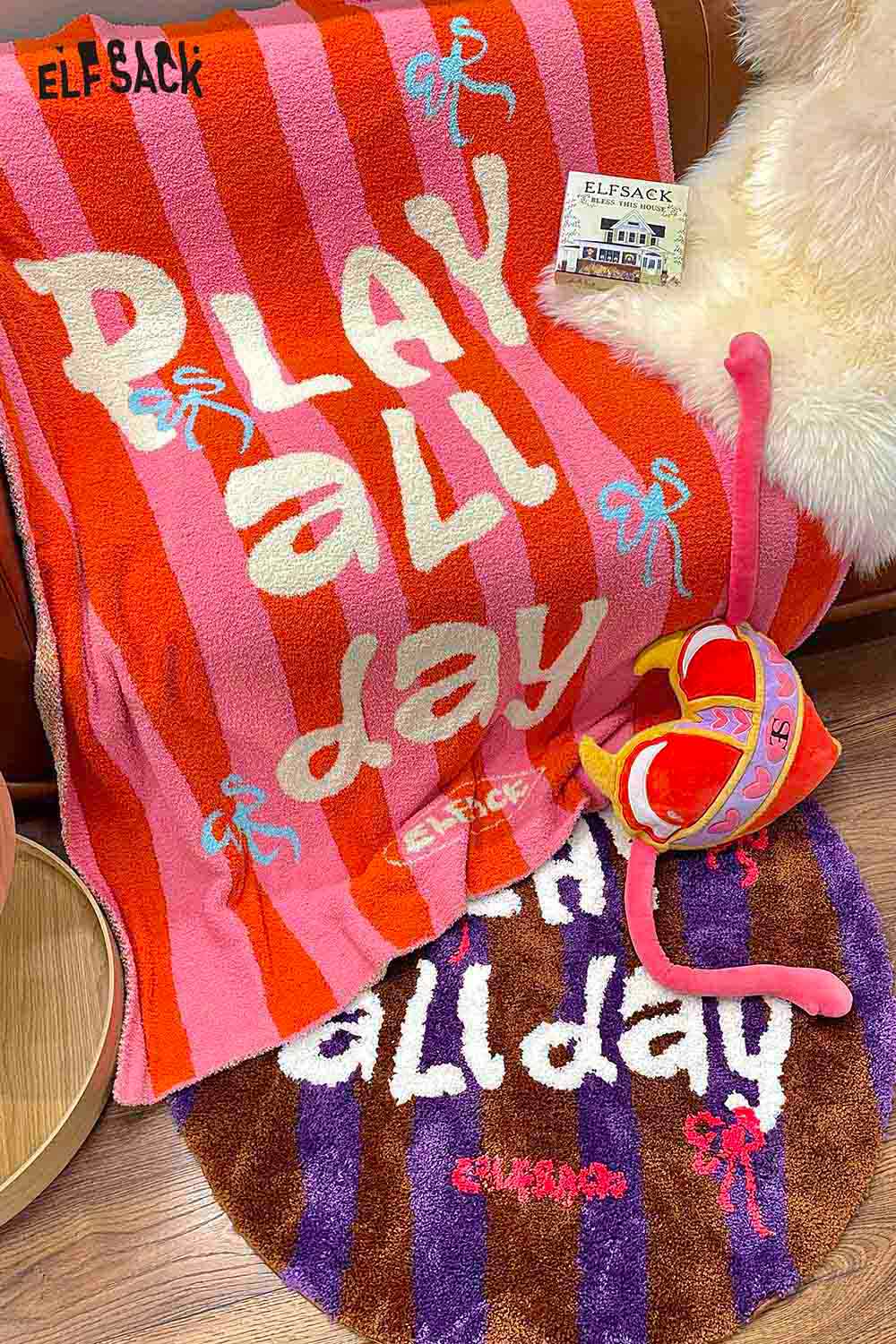 ELFSACK striped color block home blanket in vibrant pink and orange, featuring playful text and designs
