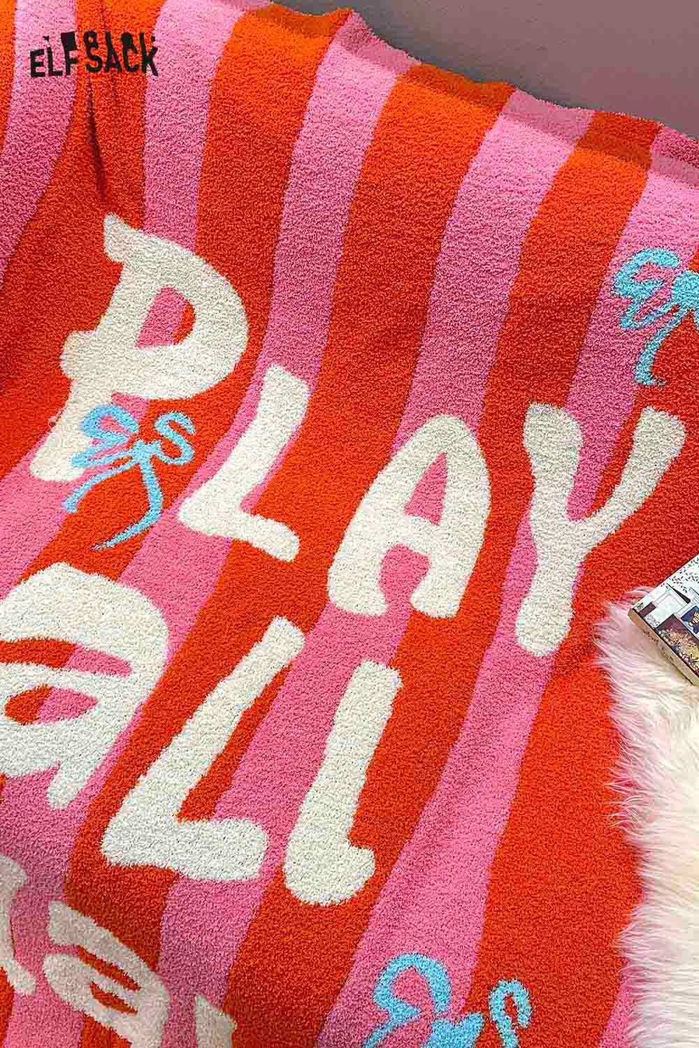 ELFSACK striped color block home blanket featuring playful text design in vibrant colors