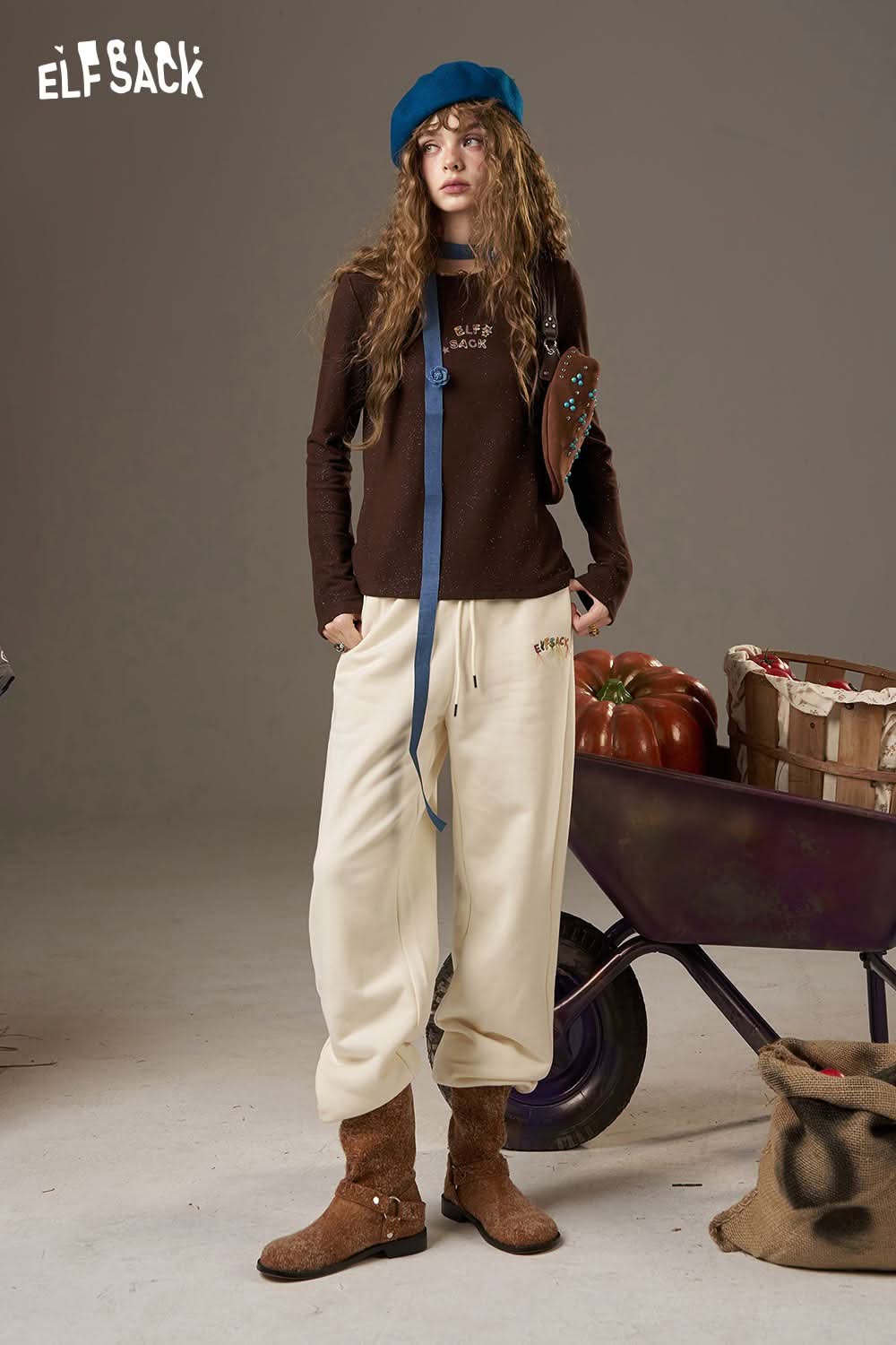 ELFSACK model showcasing stylish white cropped sweat pants for women with a cozy top and accessories