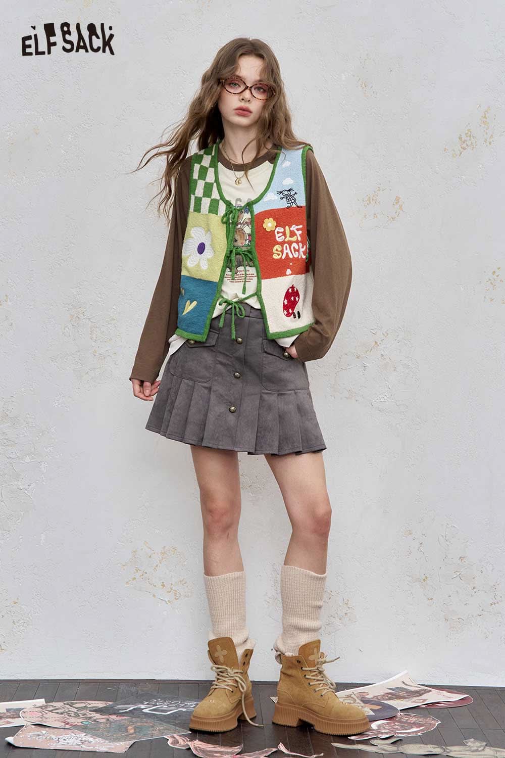 ELFSACK women's raglan sleeve graphic tee styled with a colorful vest and skirt for a trendy look