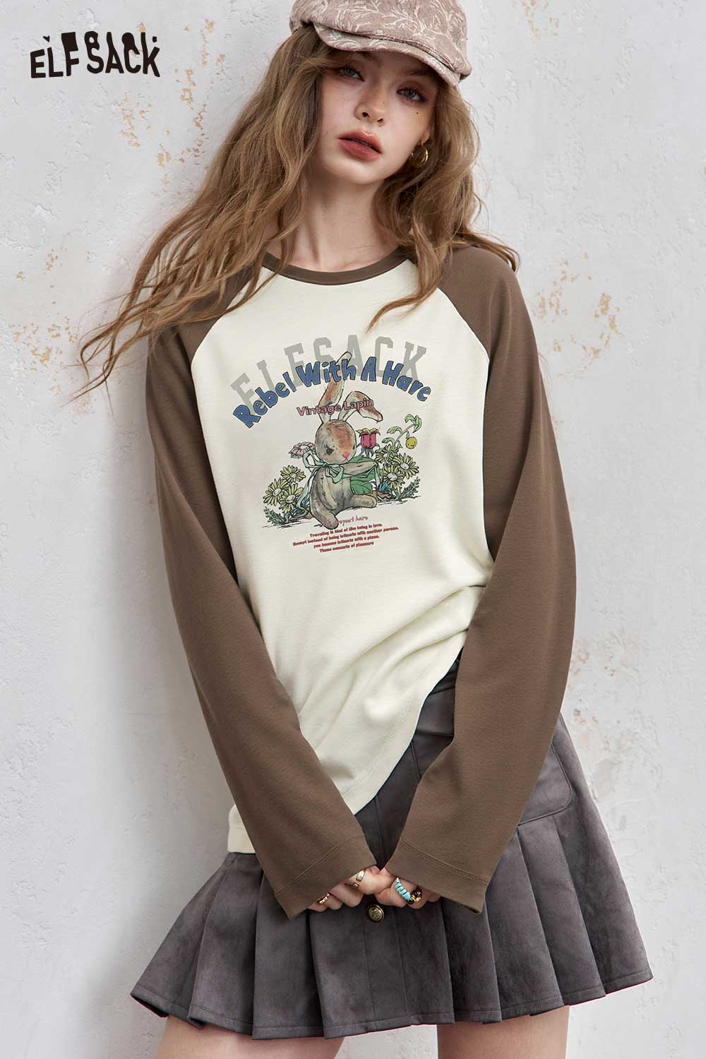ELFSACK women's raglan sleeve graphic tee featuring a playful design with earthy tones