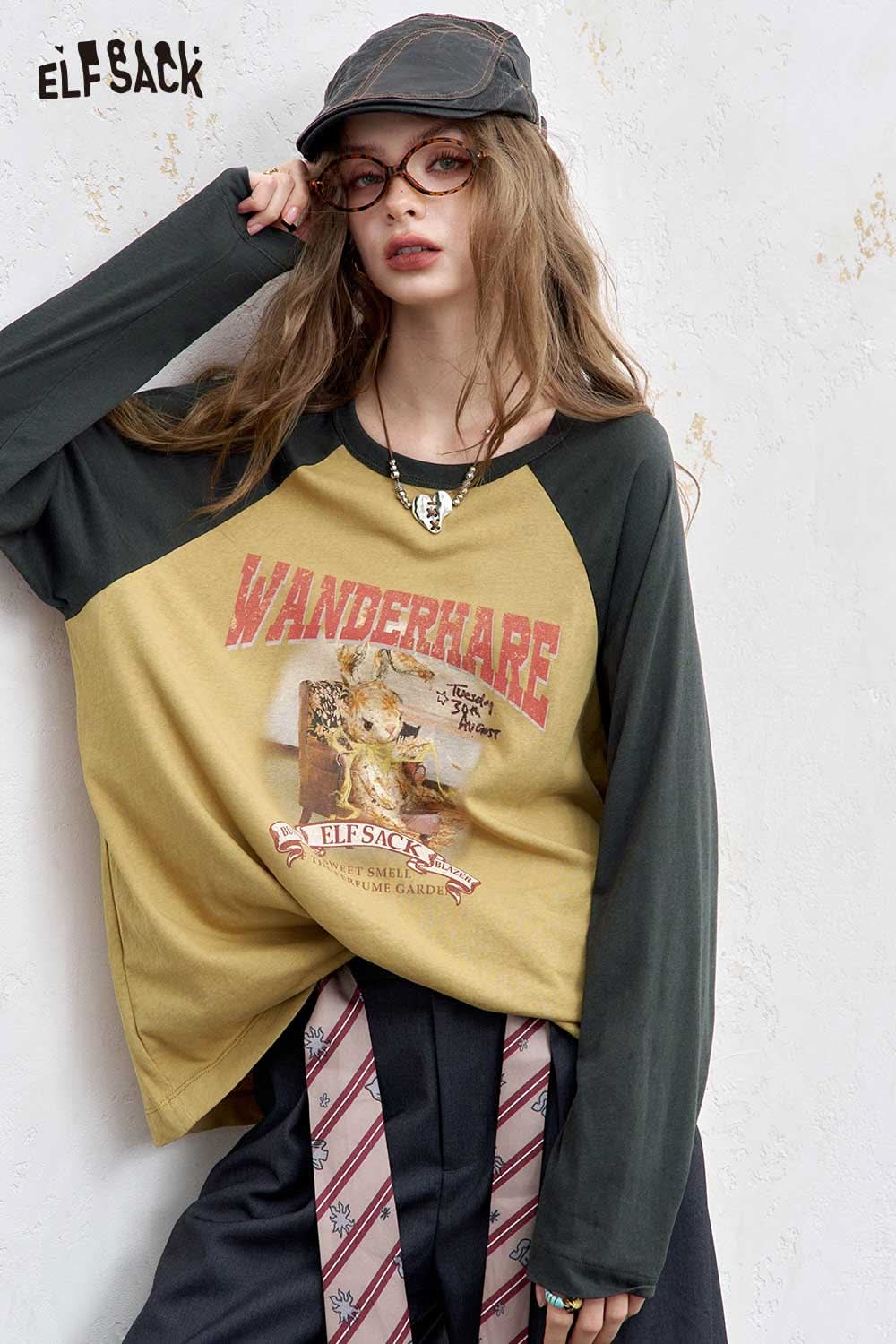 ELFSACK women's raglan sleeve graphic tee in mustard and black with a trendy design