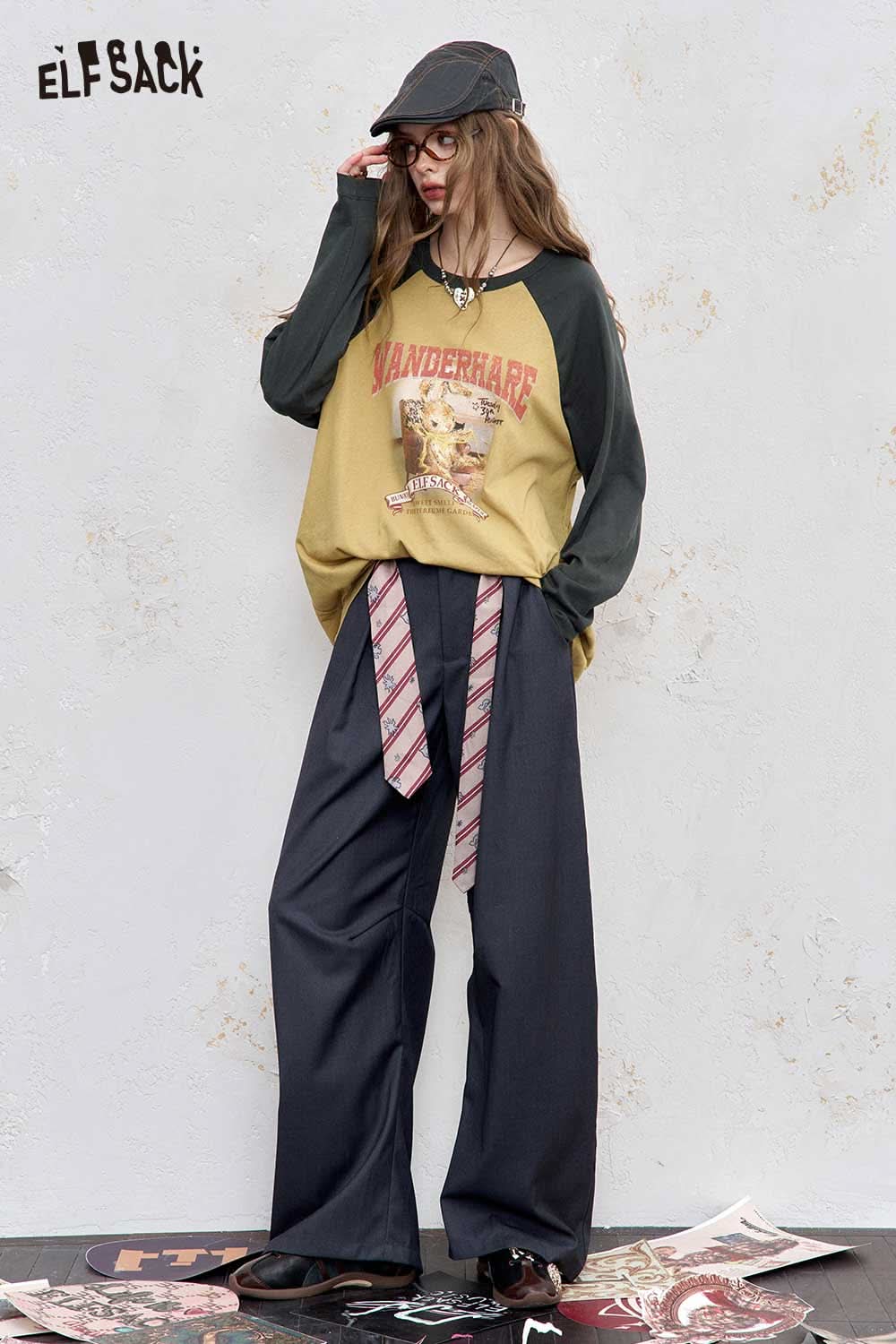 ELFSACK women's raglan sleeve graphic tee in yellow and green with vintage design, styled with wide-leg pants.