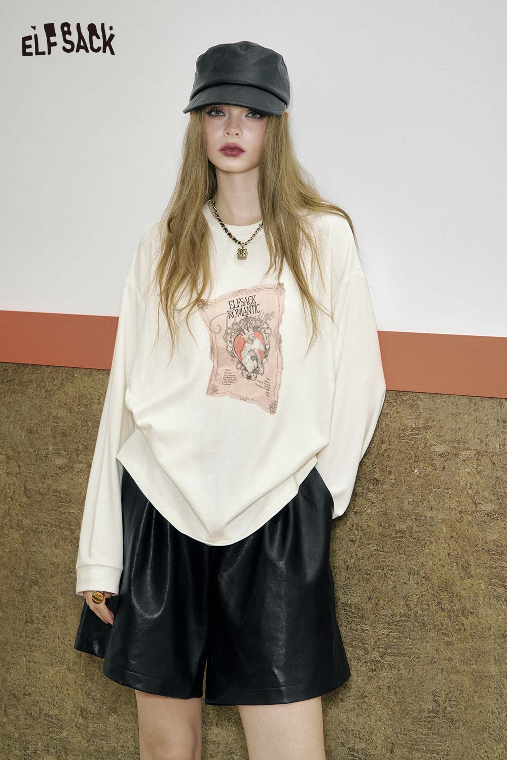 ELFSACK women's graphic print t-shirt in cream color with artistic design, paired with black shorts