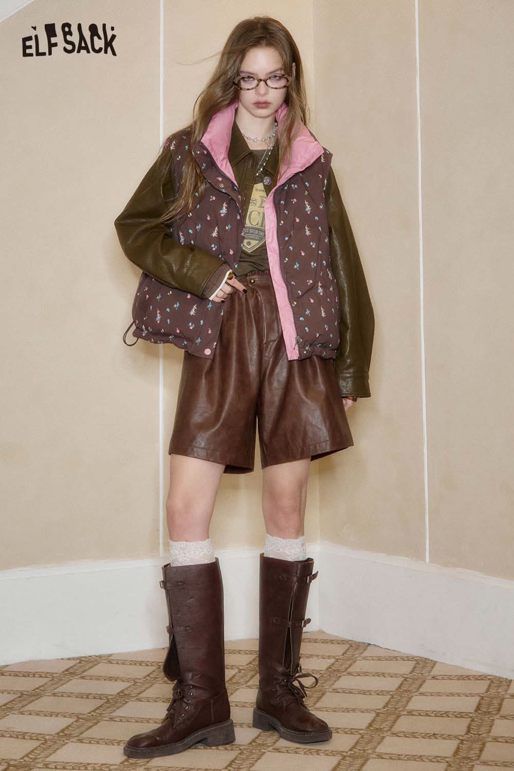 ELFSACK embroidered fitted long sleeve tee styled with a brown vest and leather shorts