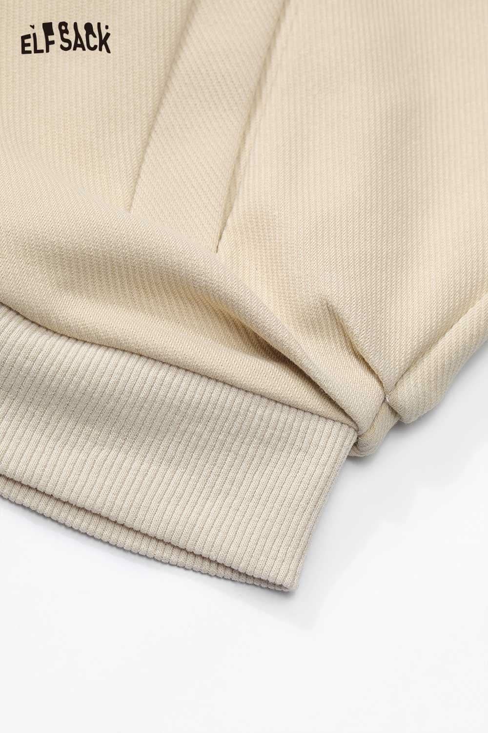 Close-up of ELFSACK embroidered hooded sweatshirt for women in beige ribbed fabric with cuffs