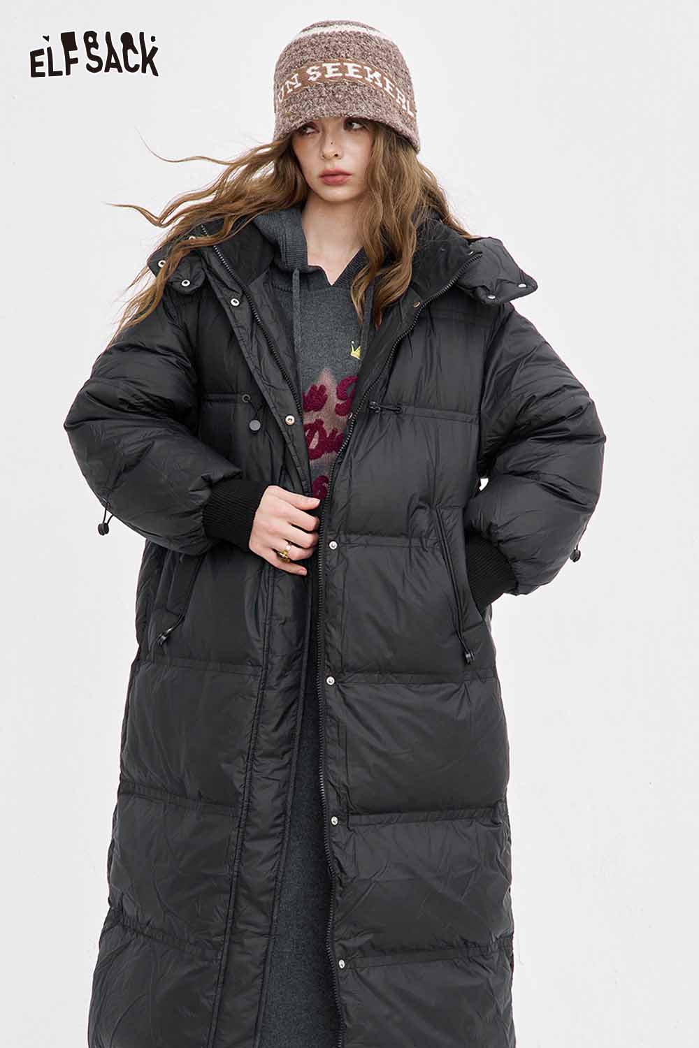ELFSACK black puffer coat layered over an embroidered long dress for women in a stylish winter look