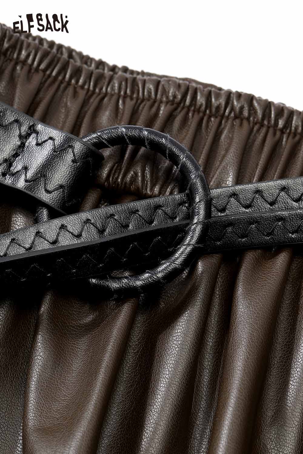 Close-up of ELFSACK faux leather maxi skirt showing the gathered waistband and decorative belt details