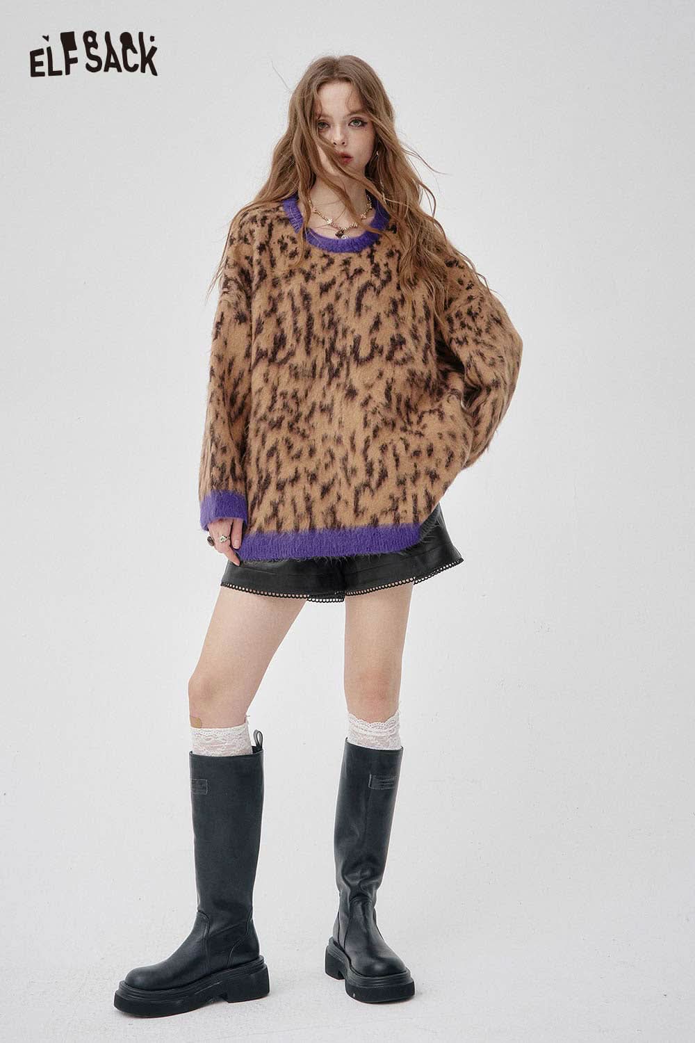 Model wearing ELFSACK faux leather shorts for women paired with a stylish sweater and long boots