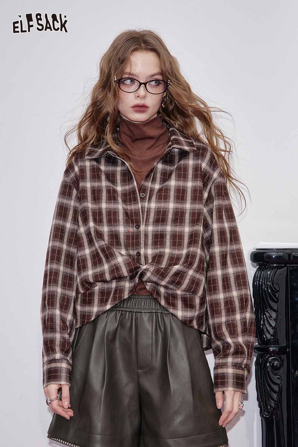 Trendy ELFSACK faux leather shorts for women paired with a plaid shirt, perfect for stylish casual wear