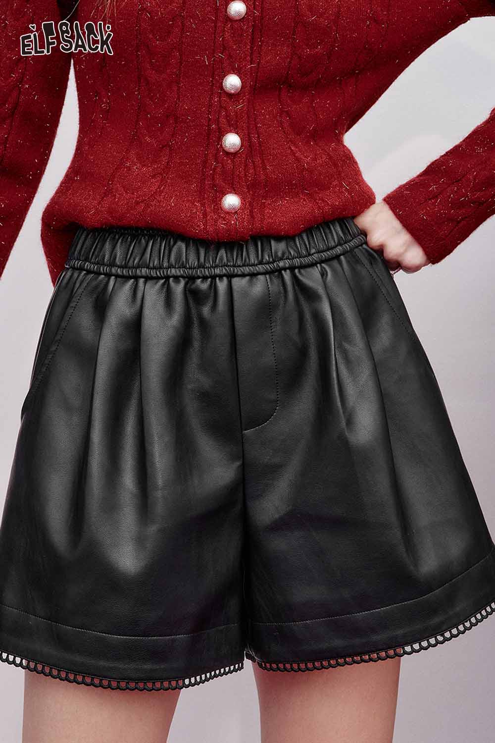 Black faux leather shorts for women with an elastic waistband and decorative hem by ELFSACK