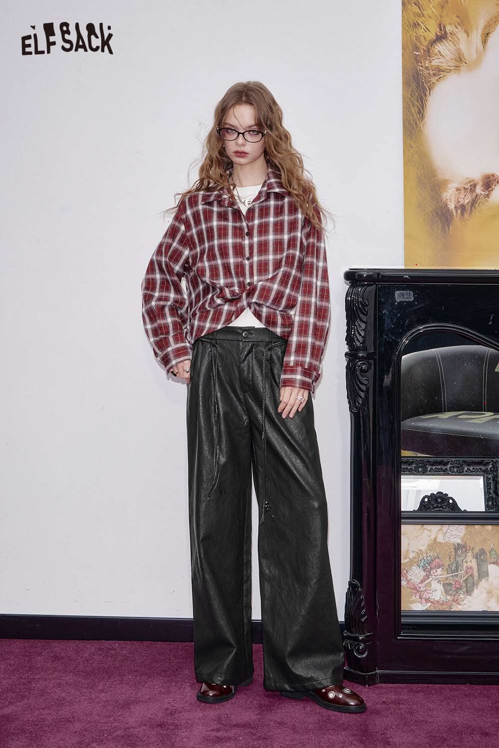 ELFSACK faux leather wide leg trousers styled with a plaid jacket in a vintage interior setting