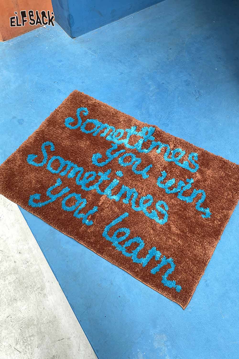 ELFSACK felted wool rug with typography featuring a motivational quote in vibrant colors