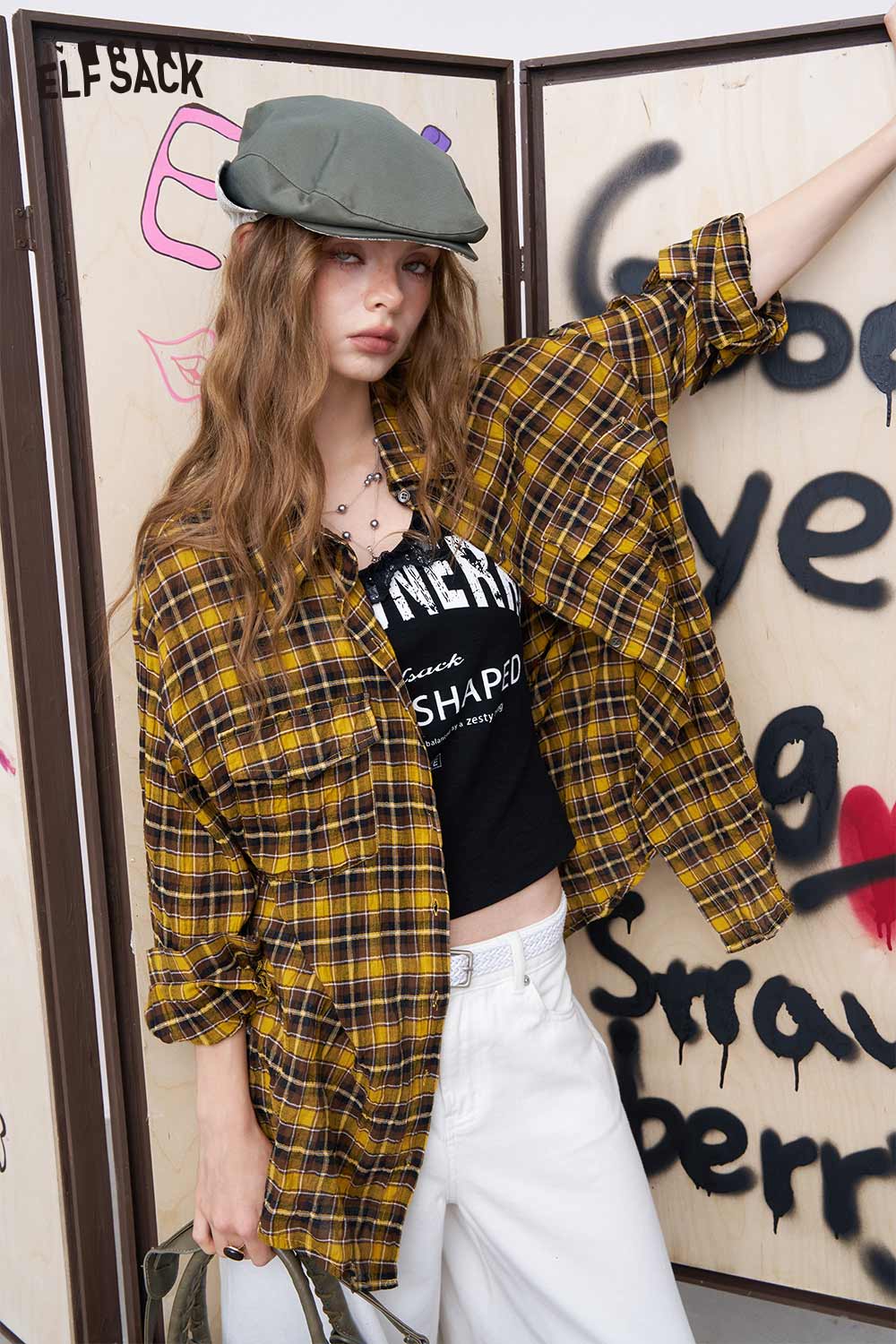 ELFSACK model wearing lace patchwork camisole for women layered under yellow plaid shirt with white jeans and green cap