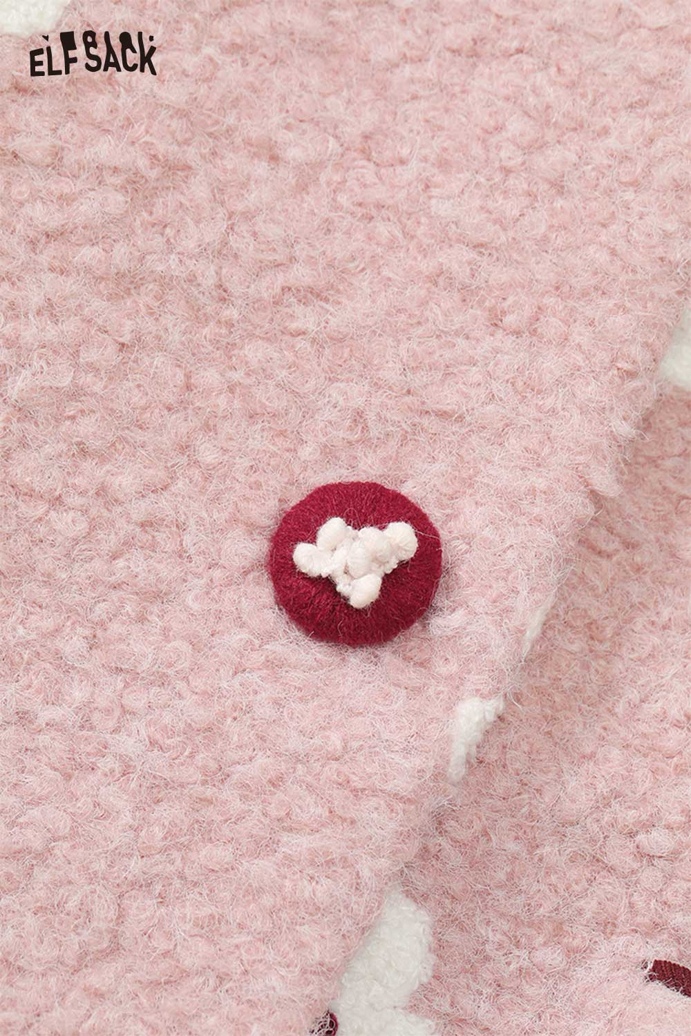 Close-up of ELFSACK floral graphic cotton coat for women featuring a textured pink fabric and decorative button