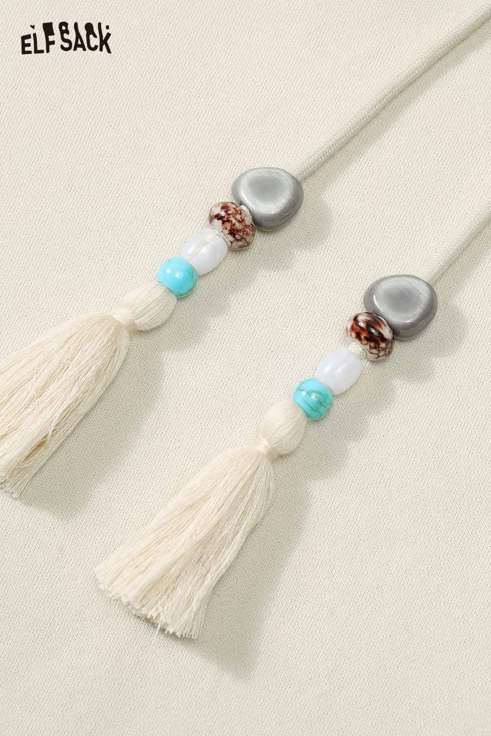 Detail of ELFSACK floral graphic tassel hoodie for women with decorative beaded drawstrings