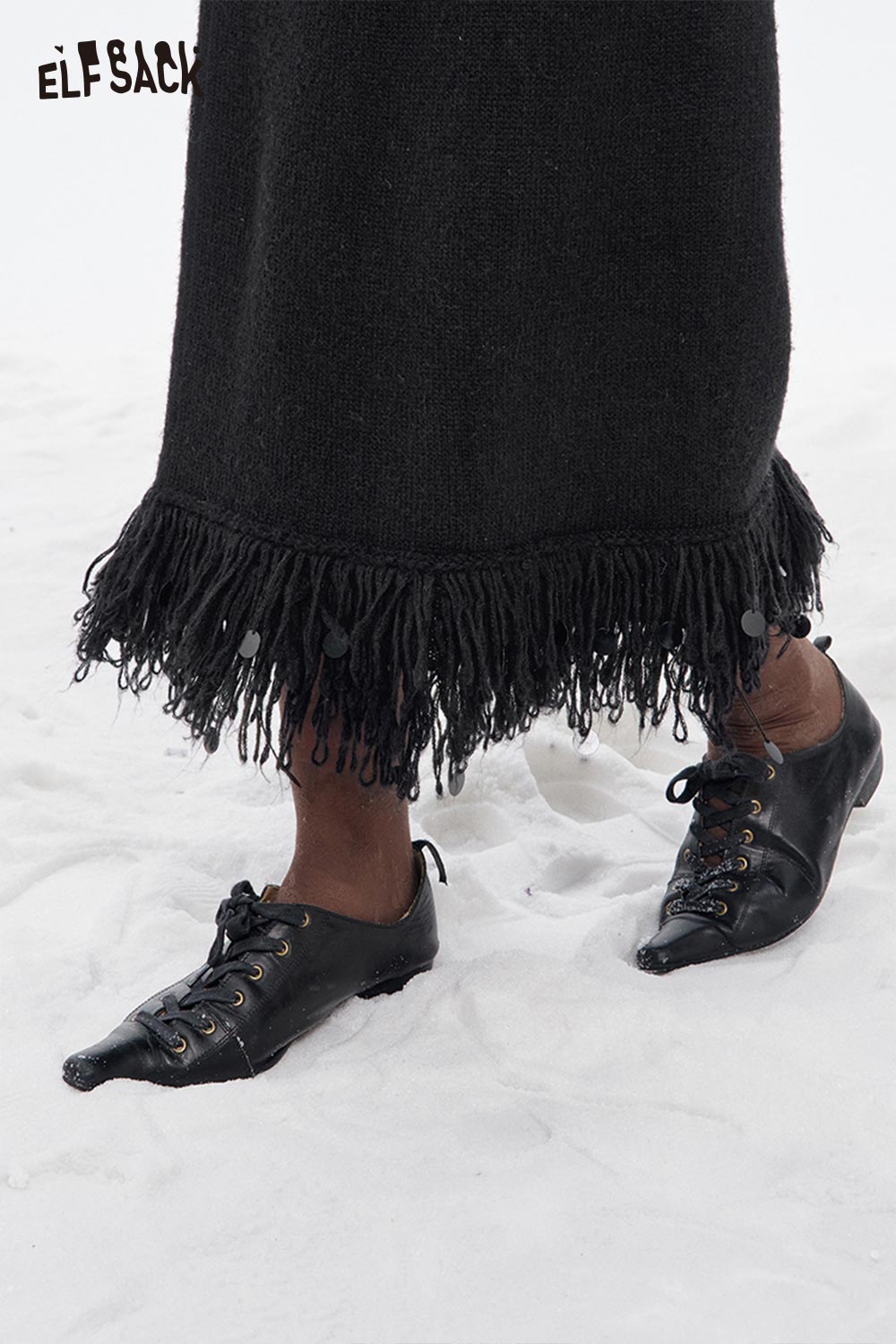 Black ELFSACK fringe hem long skirt featuring a stylish and unique fringe detail