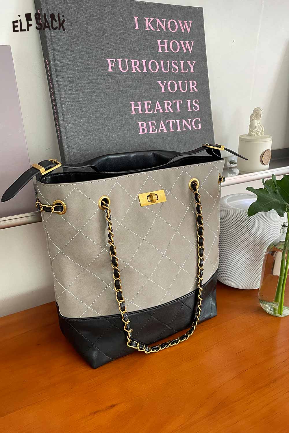 ELFSACK genuine leather bucket bag with quilted design and chain straps in stylish two-tone color