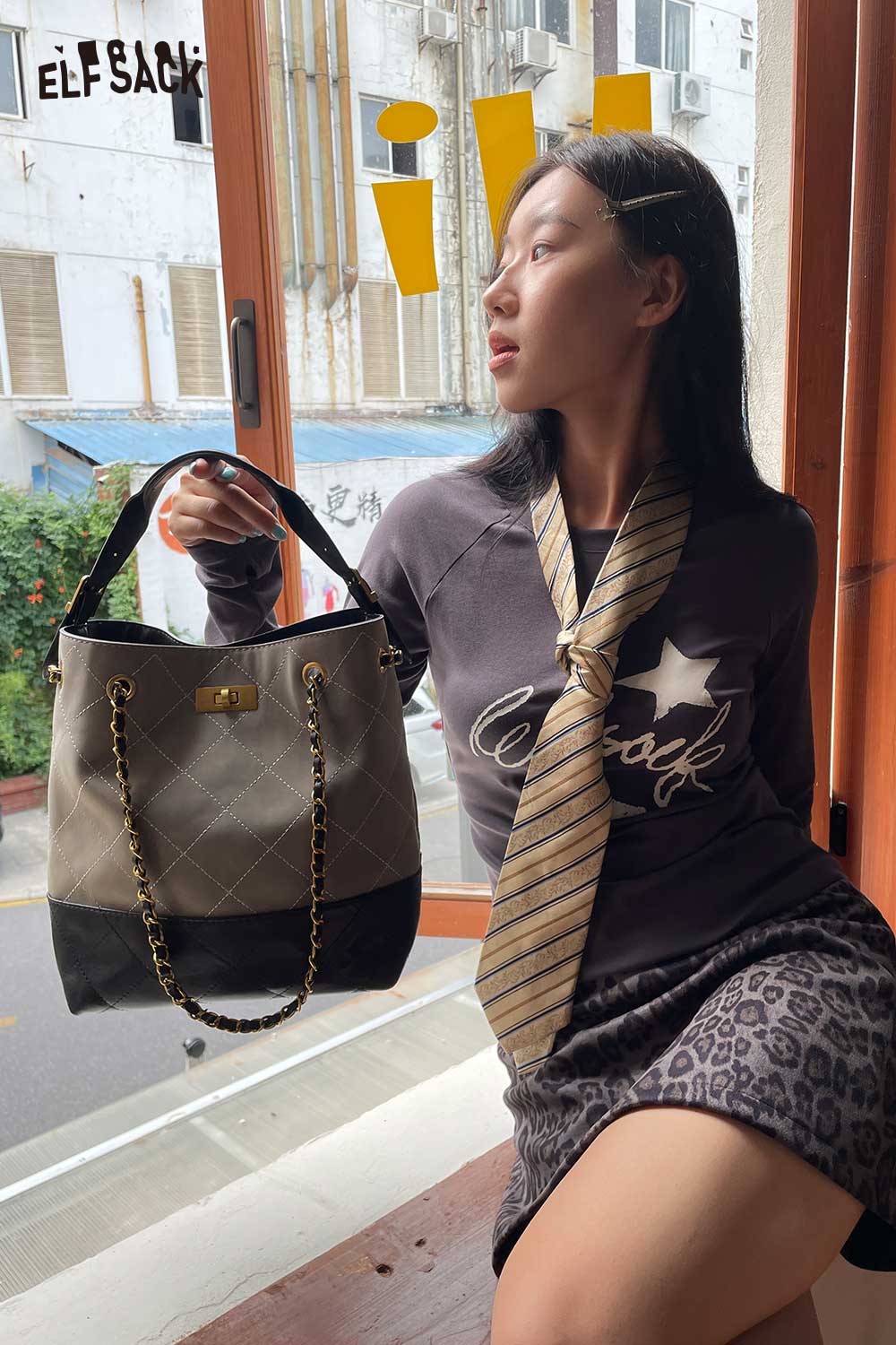 ELFSACK genuine leather bucket bag styled with casual attire for a trendy look