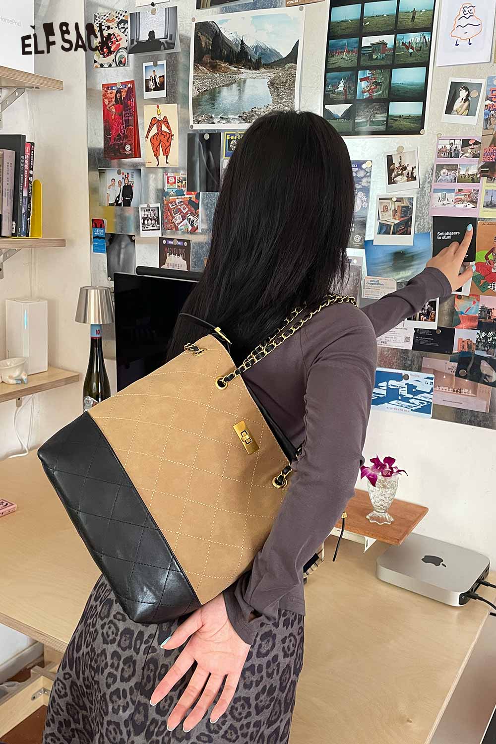 ELFSACK genuine leather bucket bag with a stylish design and adjustable chain strap in a modern setting