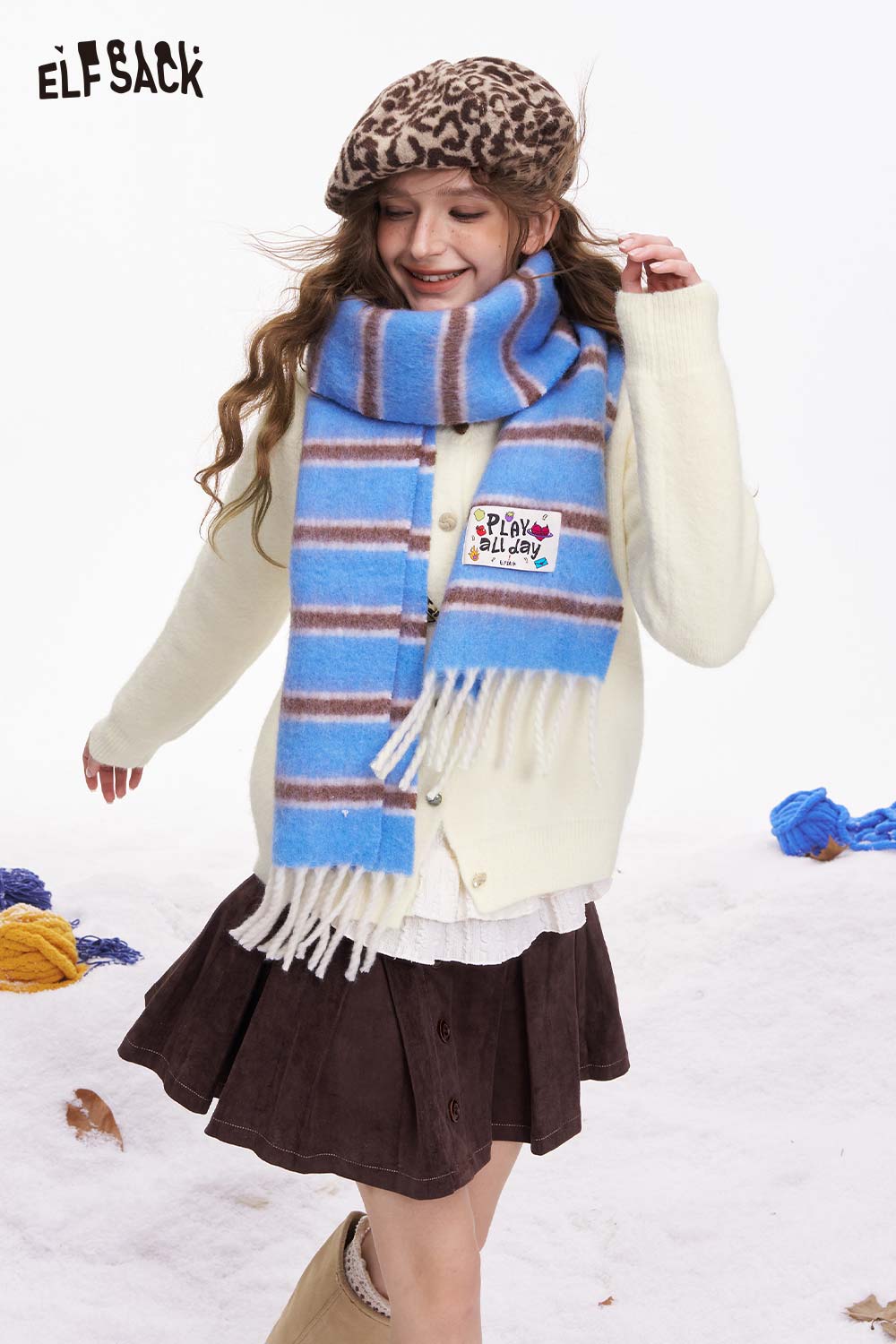 ELFSACK girly leopard bow cardigan styled with a blue striped scarf and a skirt for a trendy winter look