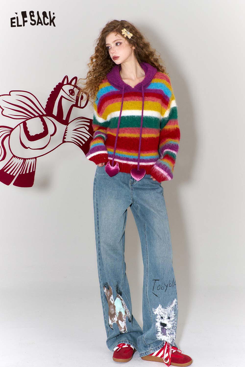 ELFSACK graffiti animal print wide leg jeans styled with a colorful striped sweater and red sneakers