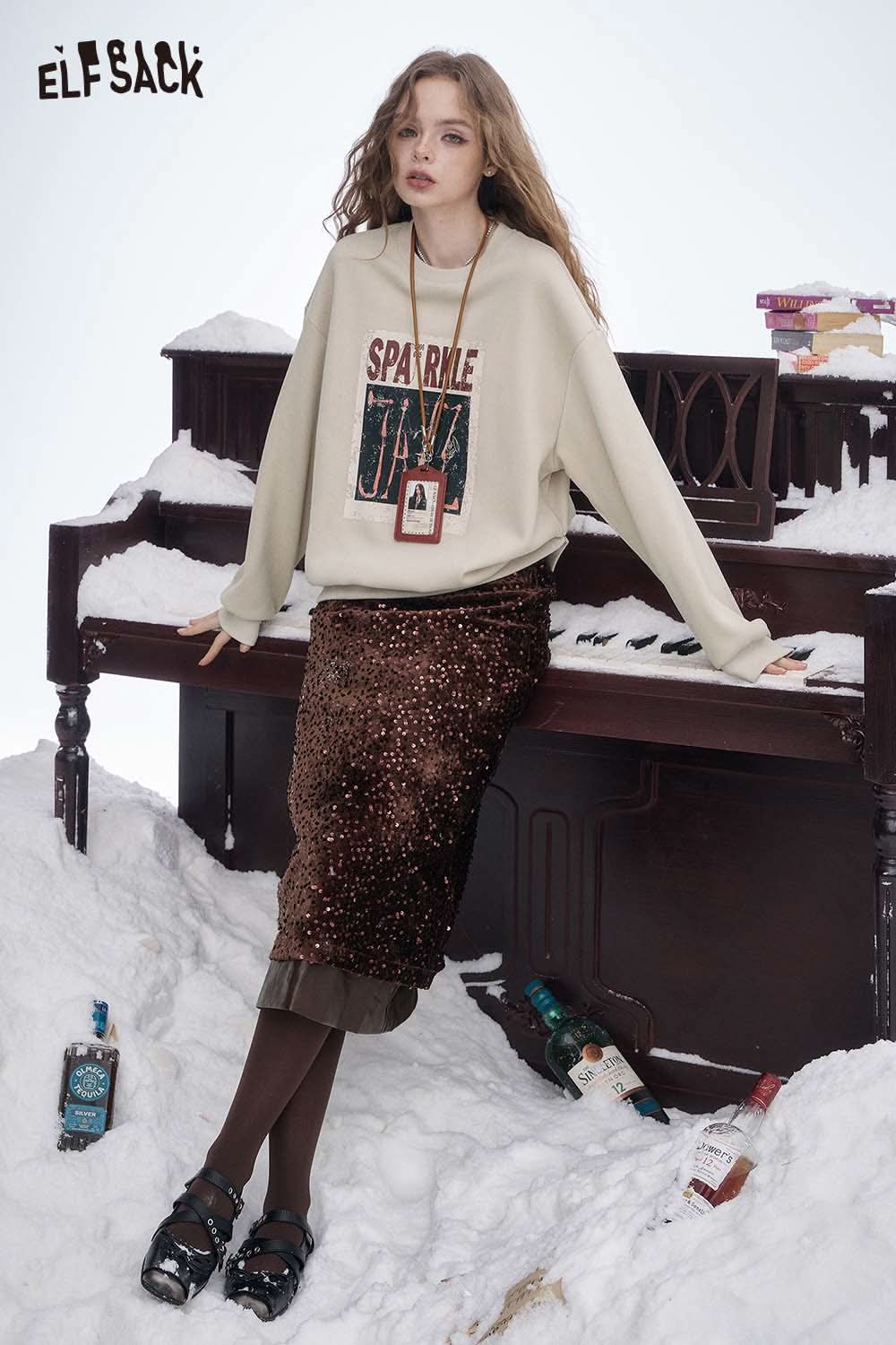 ELFSACK women's graphic sweatshirt in cream with Sparkle Jazz print, styled with a chic skirt
