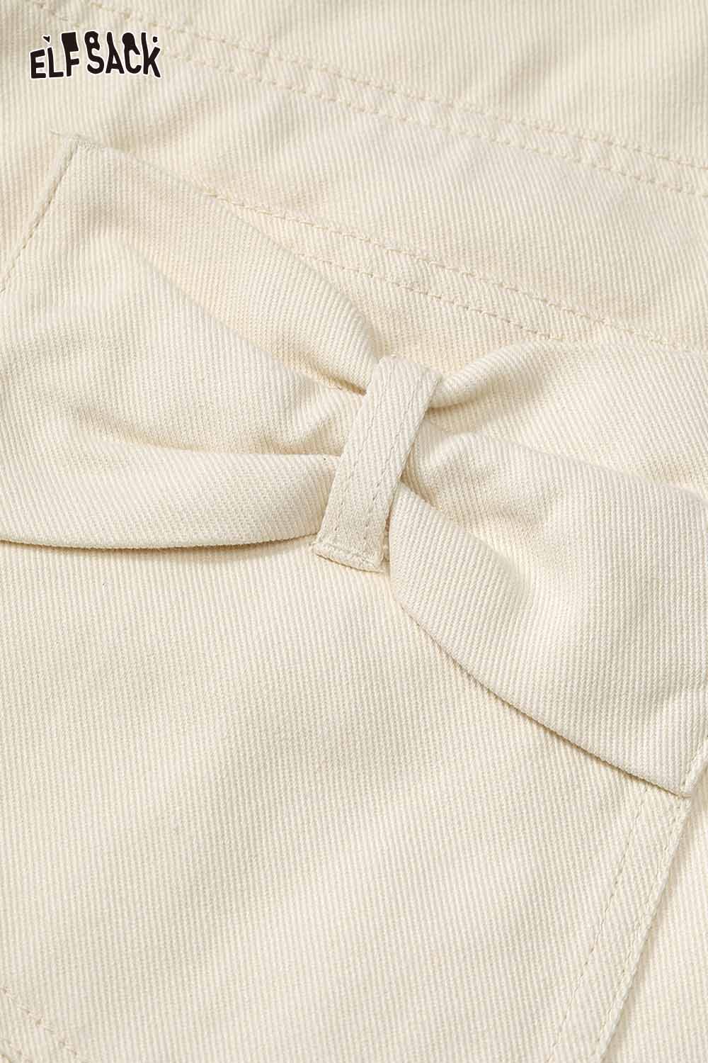 Close-up of ELFSACK heart embroidery white wide leg jeans showcasing a cute bow detail