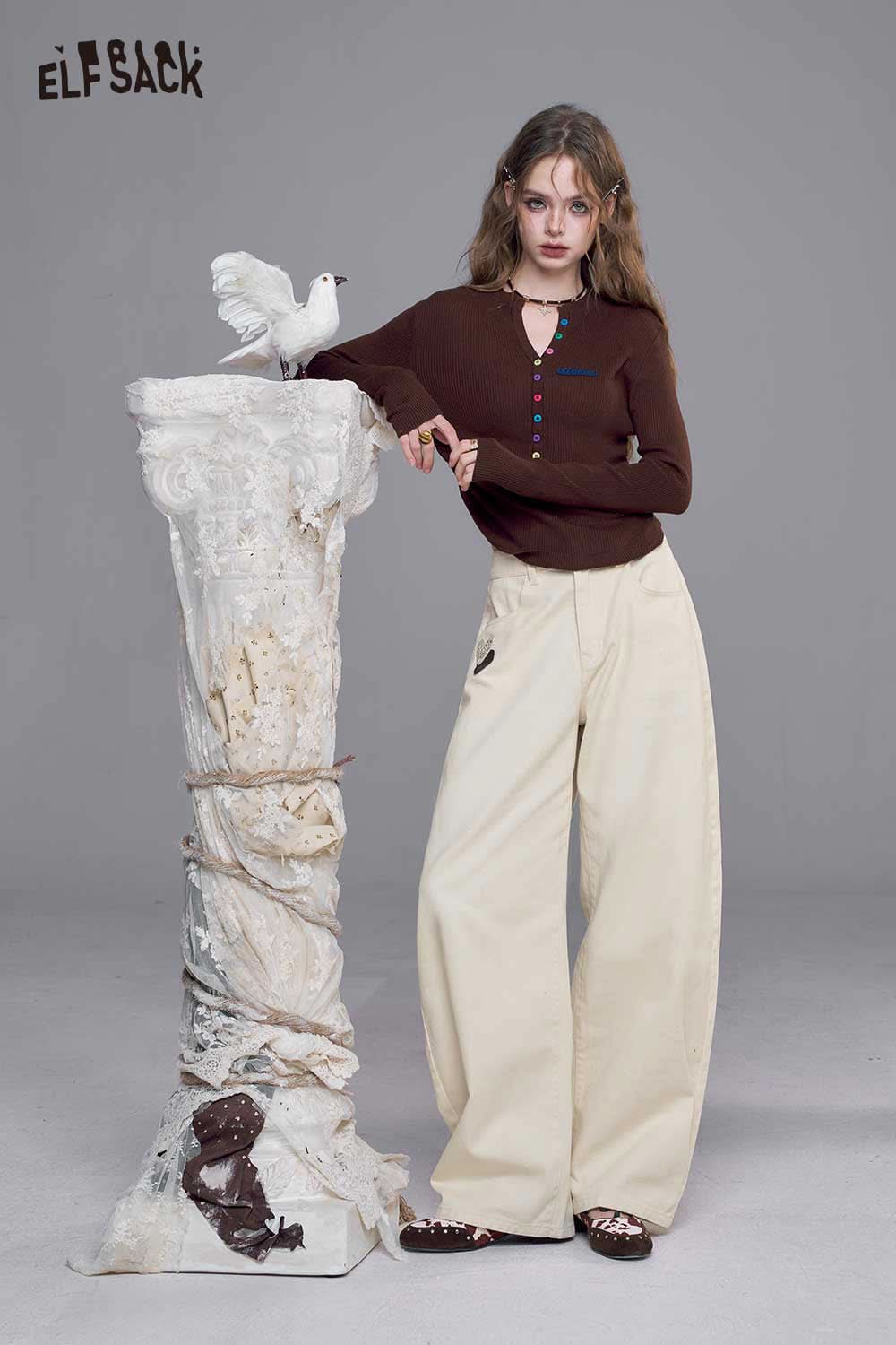 Model wearing heart embroidery white wide leg jeans paired with a brown long-sleeve top from ELFSACK