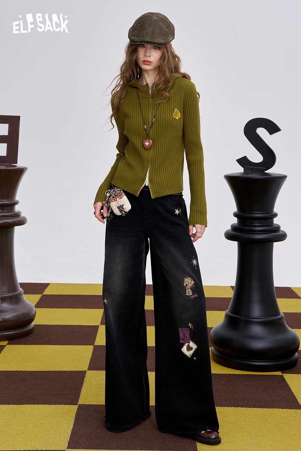 ELFSACK heart print knit sweater in olive green, styled with wide-leg black trousers and a stylish hat