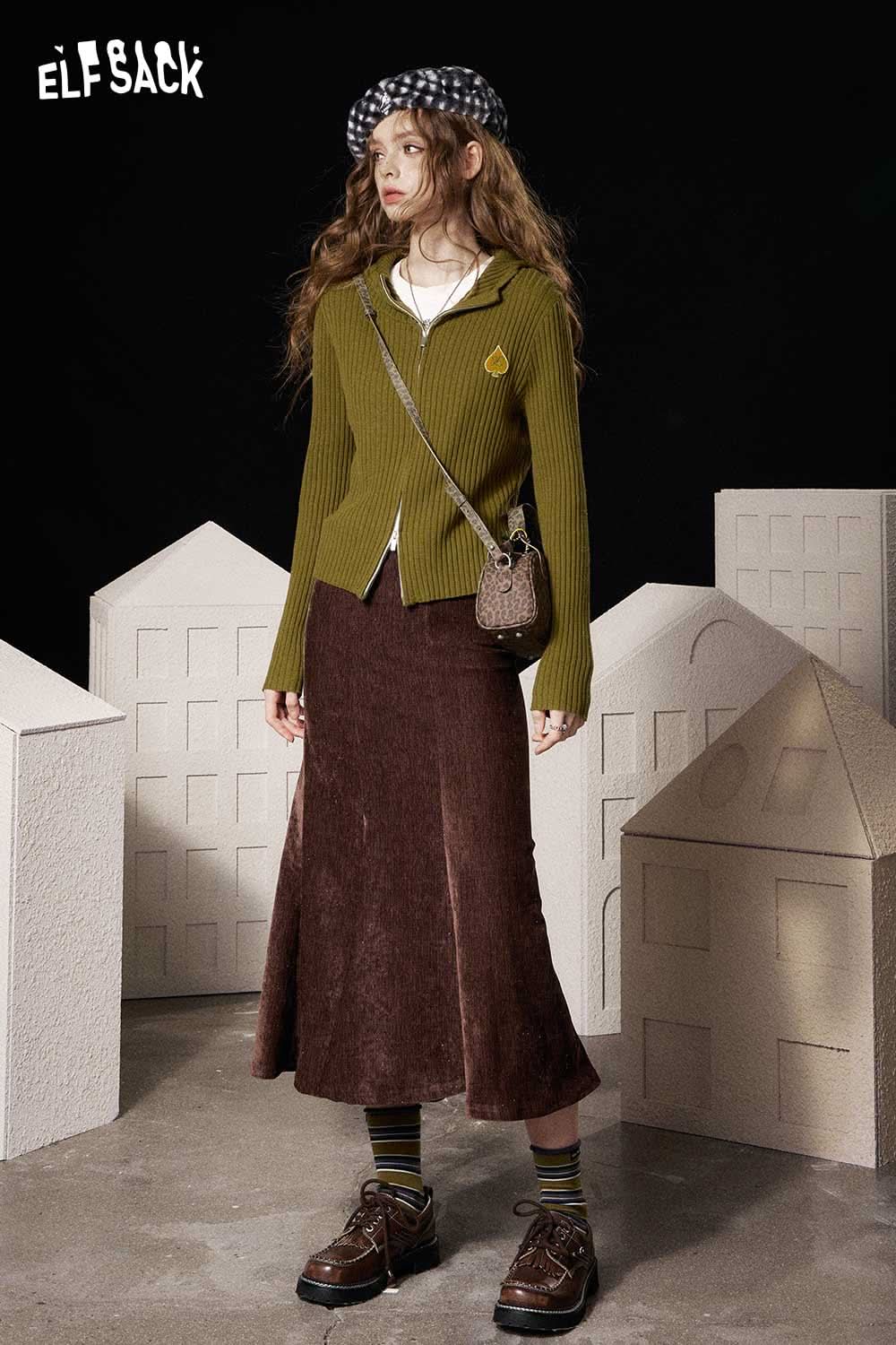 ELFSACK heart print knit sweater in olive green paired with a brown midi skirt and accessories
