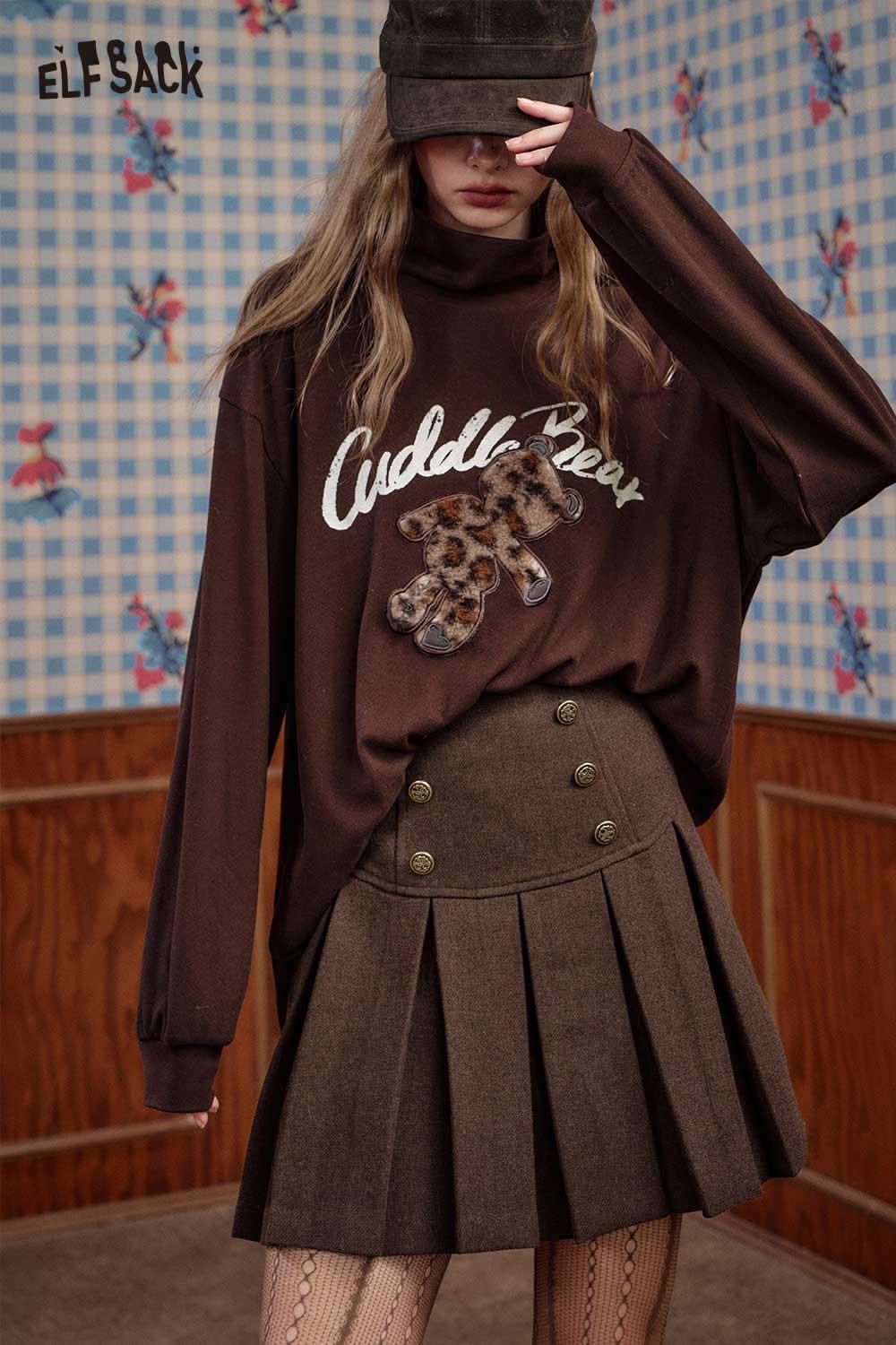 ELFSACK high-rise button front pleated skirt paired with a stylish oversized brown sweater
