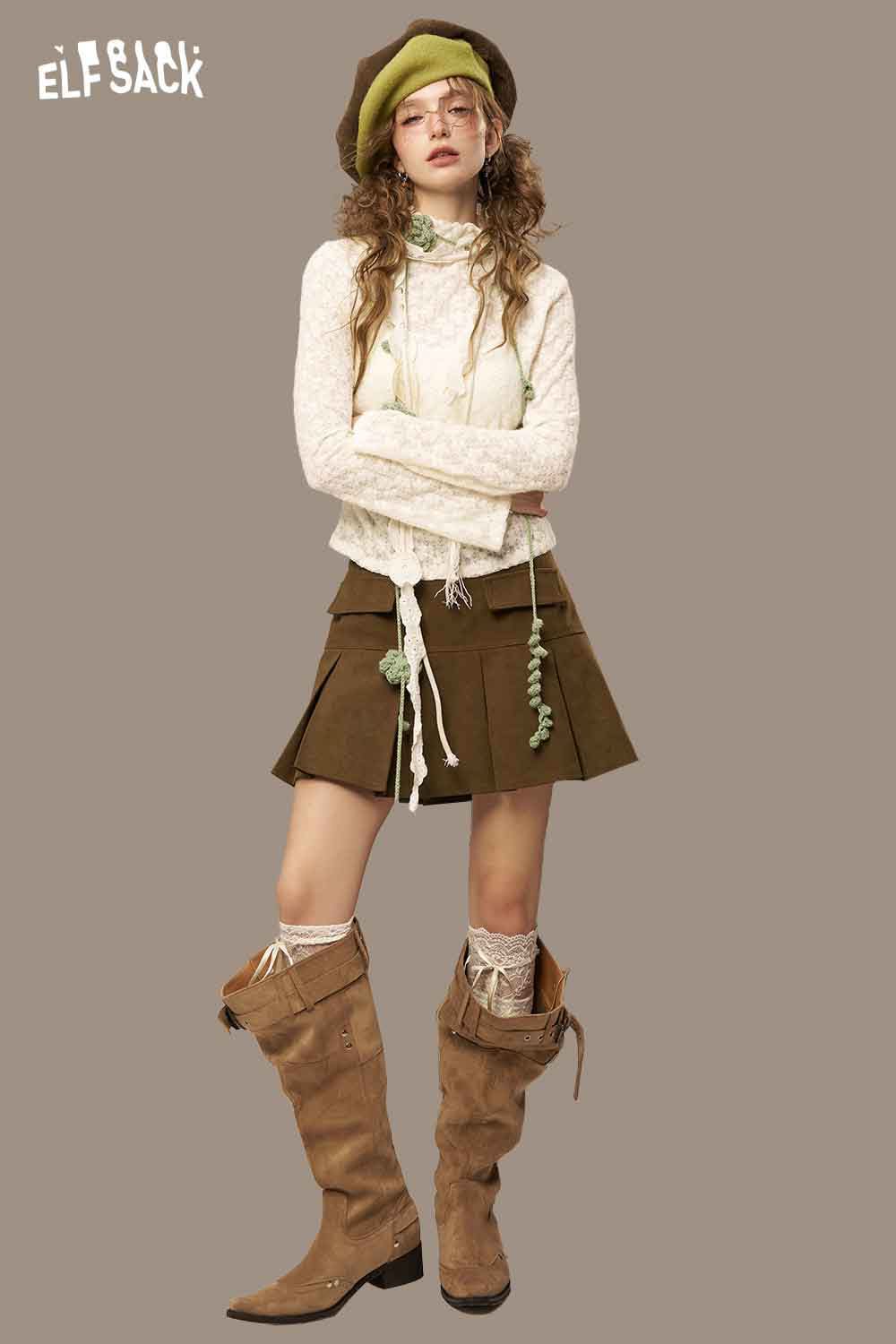 ELFSACK high waist pleated skirt in brown paired with a stylish top and knee-high boots