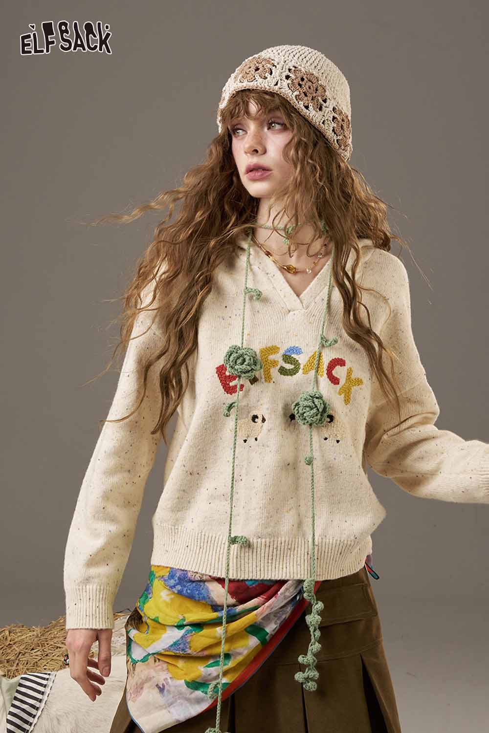 ELFSACK high waist pleated skirt in a stylish outfit featuring a colorful sweater and accessories