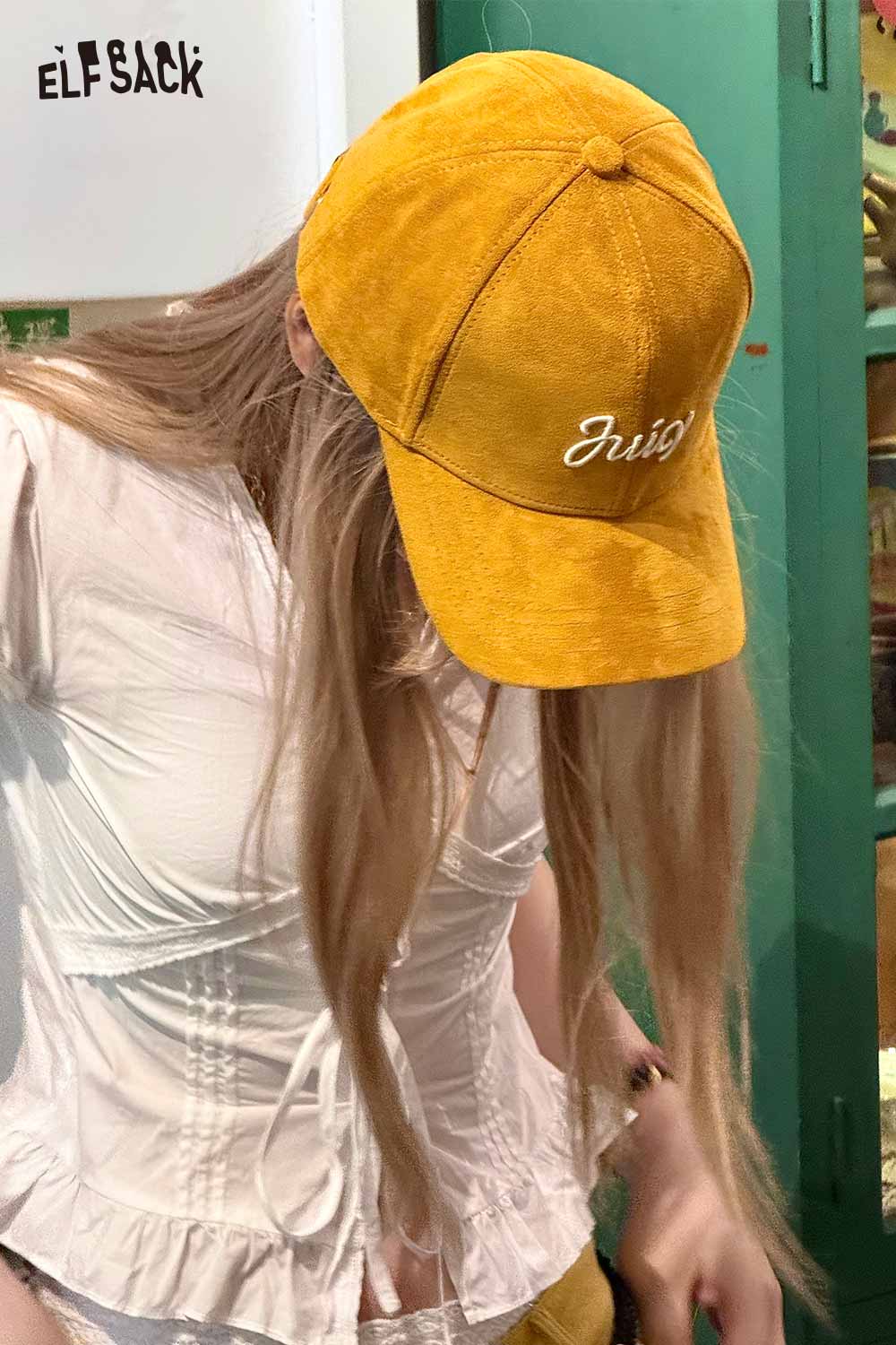 ELFSACK suede baseball cap in yellow worn by a model, perfect for casual outfits
