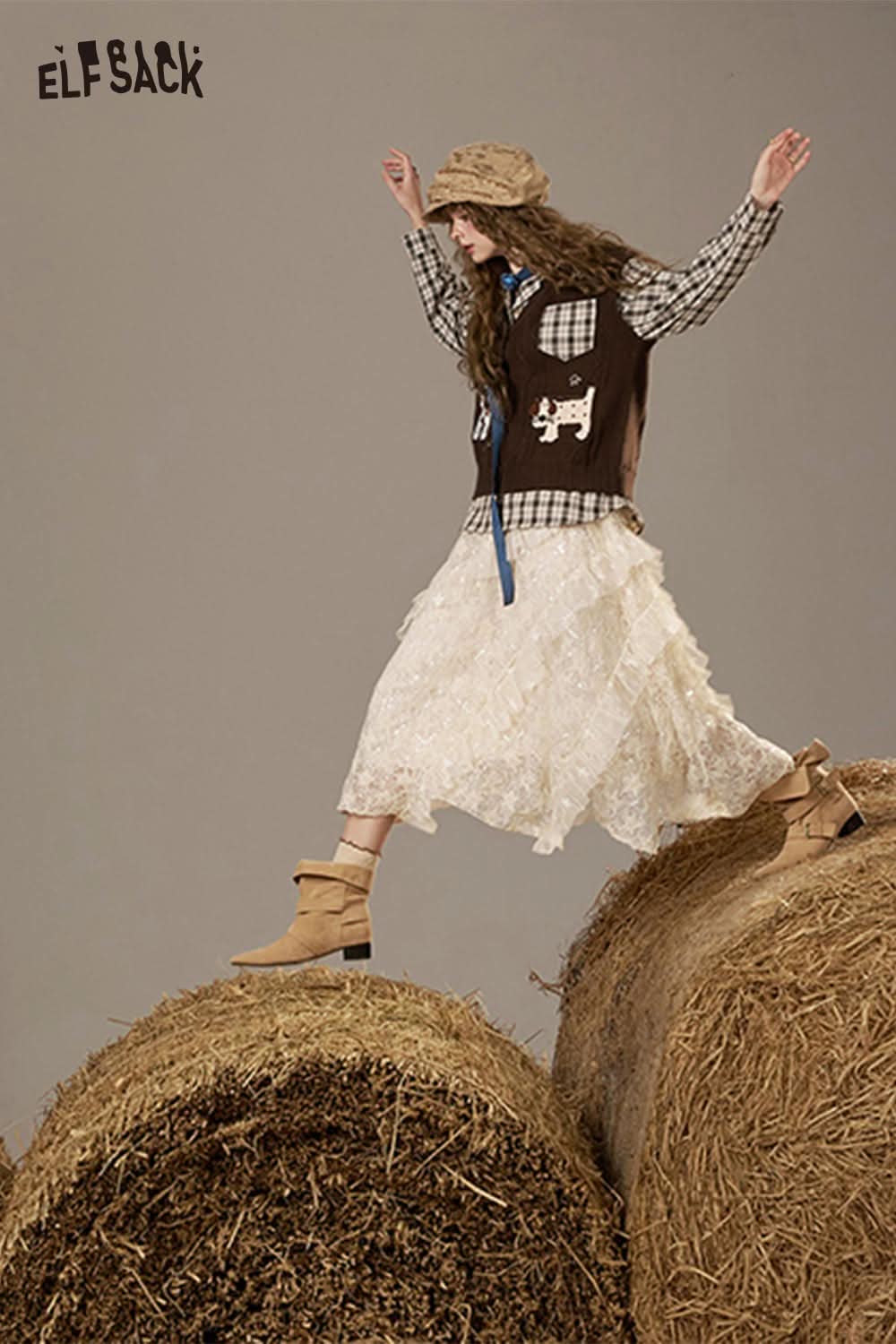 ELFSACK lace patchwork long skirt styled with a plaid shirt and hat on a haystack