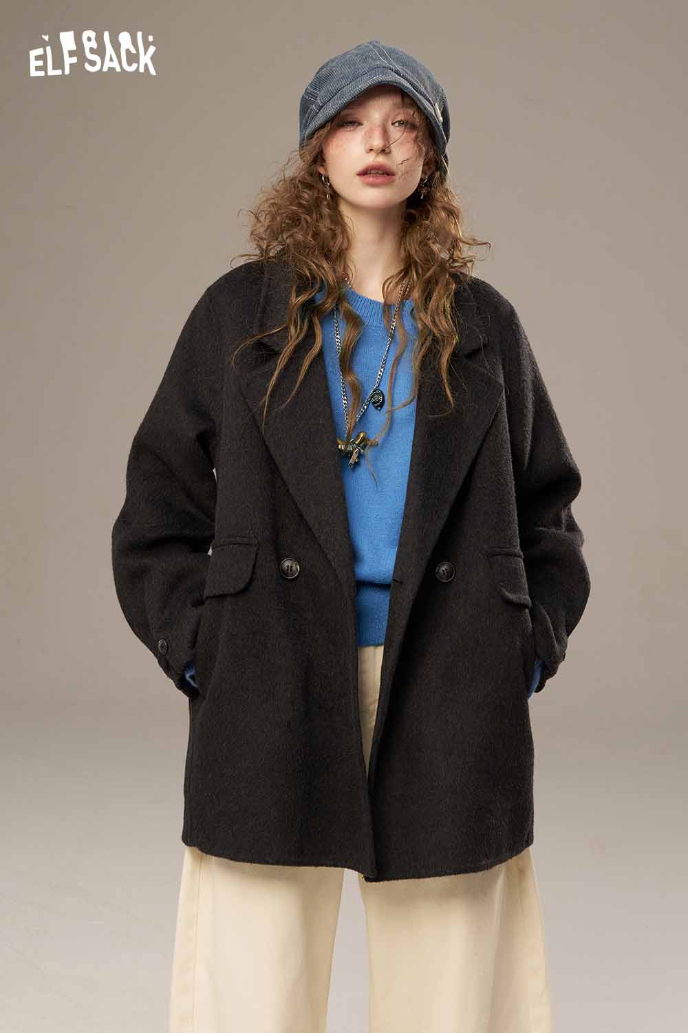 Stylish model wearing a black coat over a blue lantern sleeve fitted knitted sweater from ELFSACK