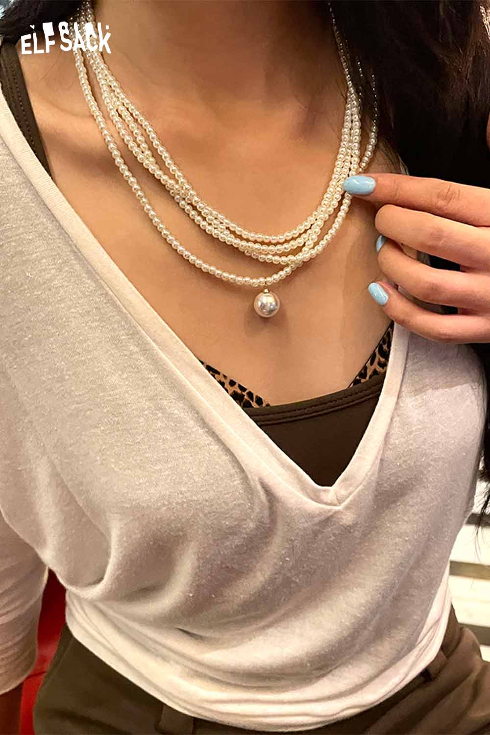 Layered pearl choker necklace worn with a stylish top, showcasing elegant multi-strand design