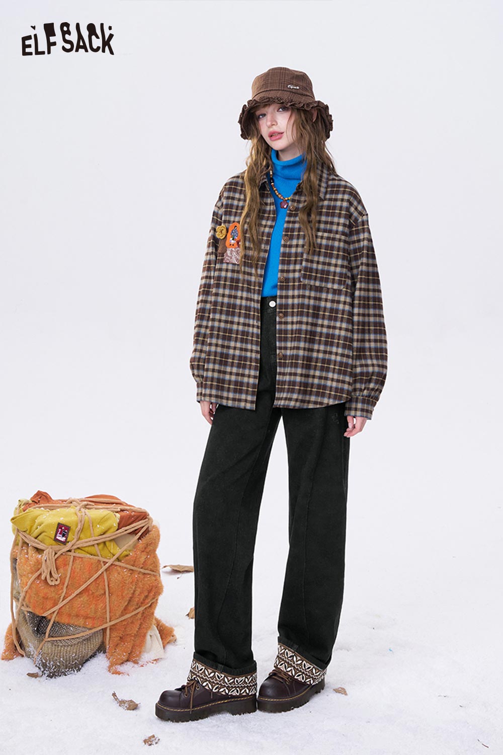 ELFSACK leaf print floor length jeans styled with a checked shirt and brown hat for a trendy look
