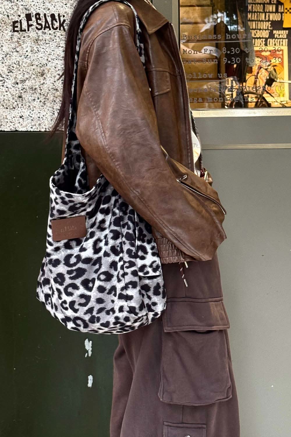 ELFSACK leopard print canvas tote bag stylishly worn with a brown leather jacket