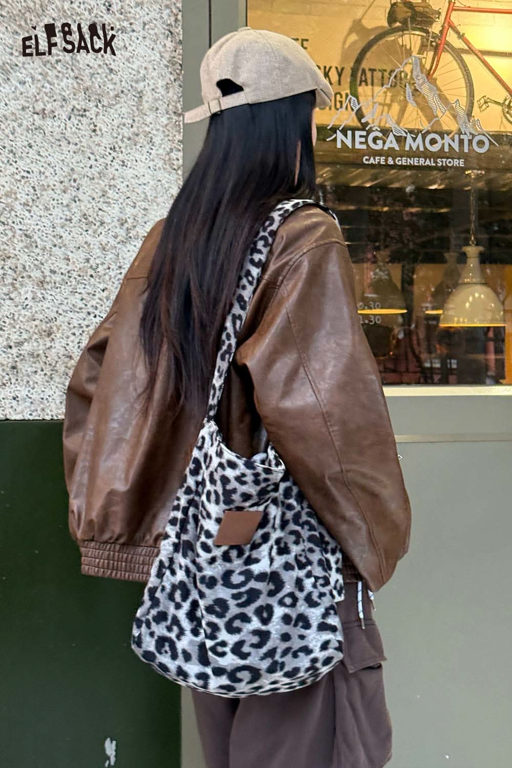 ELFSACK leopard print canvas tote bag stylishly worn by a woman with brown leather jacket