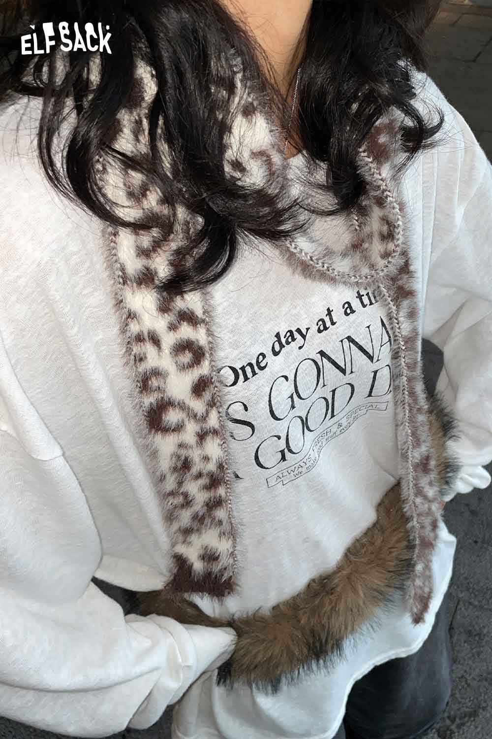 ELFSACK leopard print fuzzy scarf styled with a casual sweatshirt for a trendy look