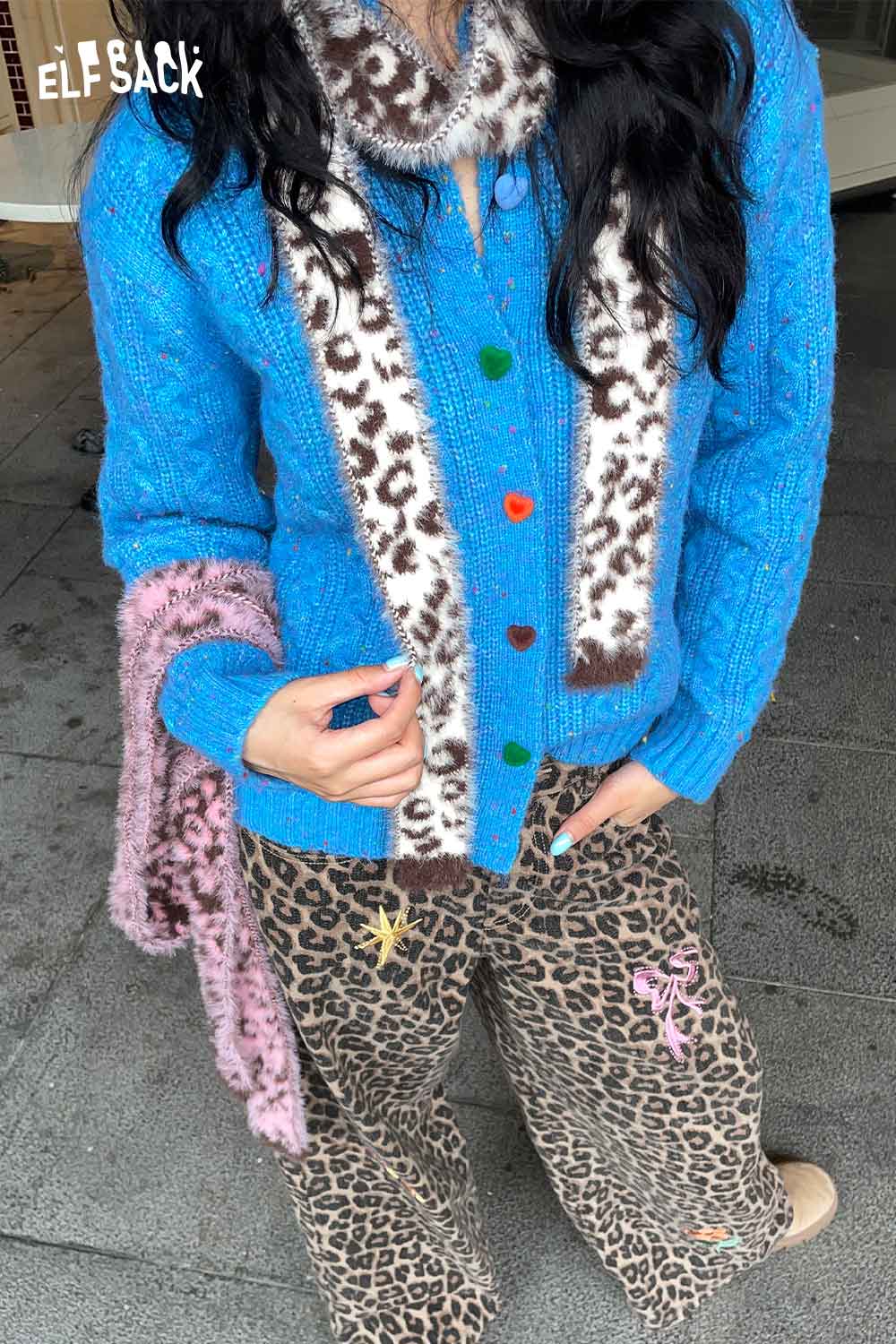 Stylish leopard print fuzzy scarf worn with a blue cardigan and animal print pants for a trendy look