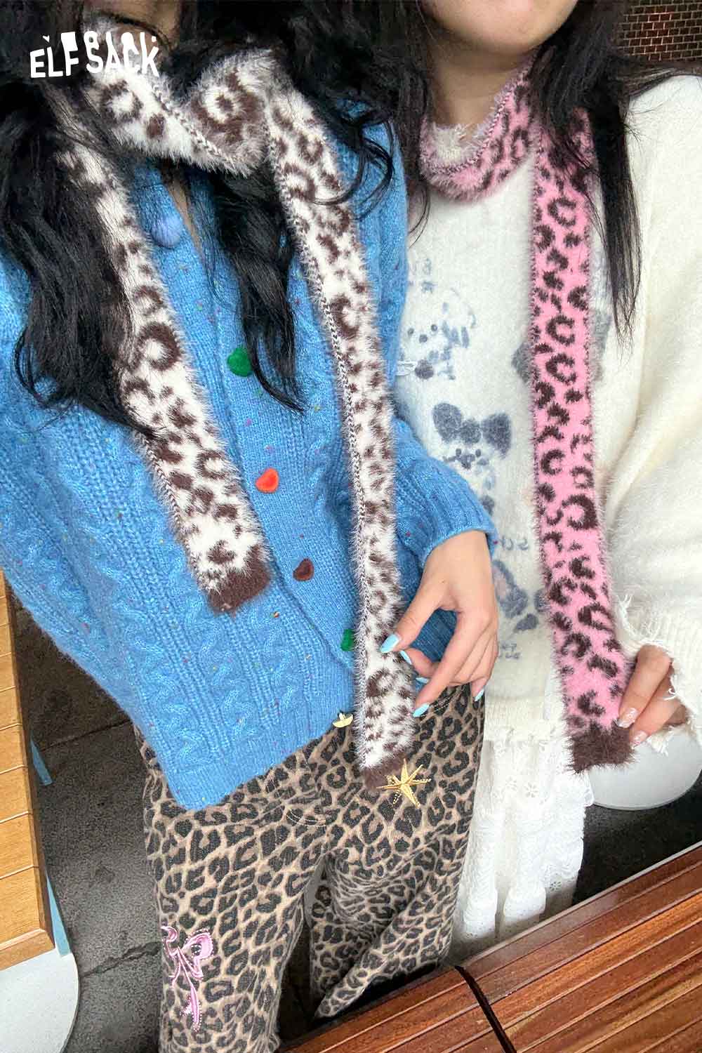Two models wearing leopard print fuzzy scarf styled with colorful cardigans for a trendy look