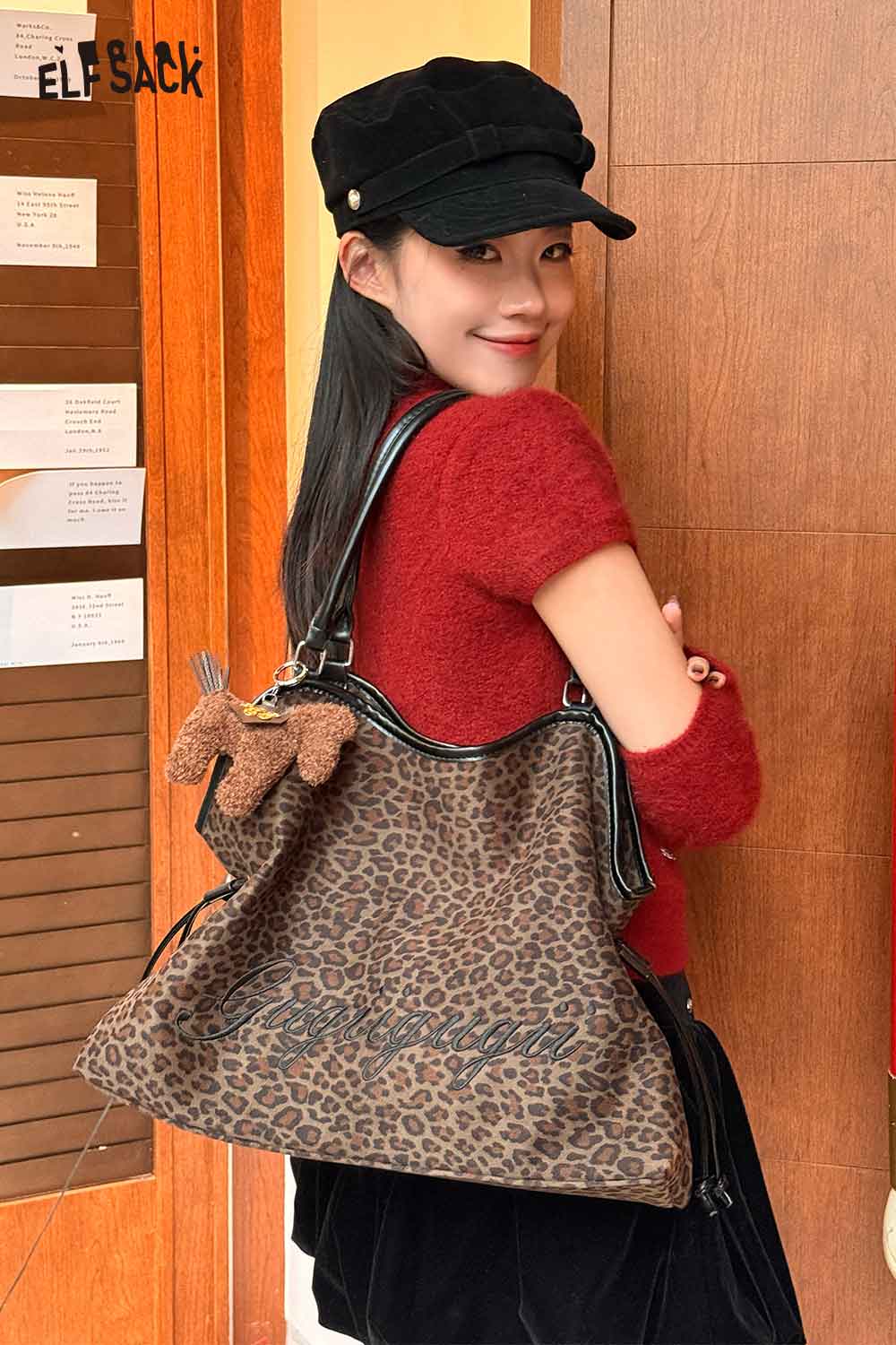 ELFSACK leopard print tote bag stylishly worn by a model with a cozy red sweater